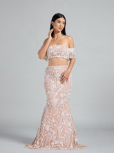Fish cut beige lehenga by DEEPANSHI MASSEY LABEL featuring intricate floral hand embroidery, an off-shoulder blouse with pearl-fringed sleeves, and a fitted mermaid silhouette.