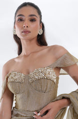Close-up of the Aurum Tissue Silk Saree by DEEPANSHI MASSEY LABEL highlighting intricate floral embellishments on the corset blouse, textured champagne-gold fabric and refined couture detailing.