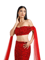 Close-up of the Crimson Reign Lehenga by DEEPANSHI MASSEY LABEL highlighting intricate red hand embroidery, shimmering embellishments and the off-shoulder blouse with detailed sleeve accents.