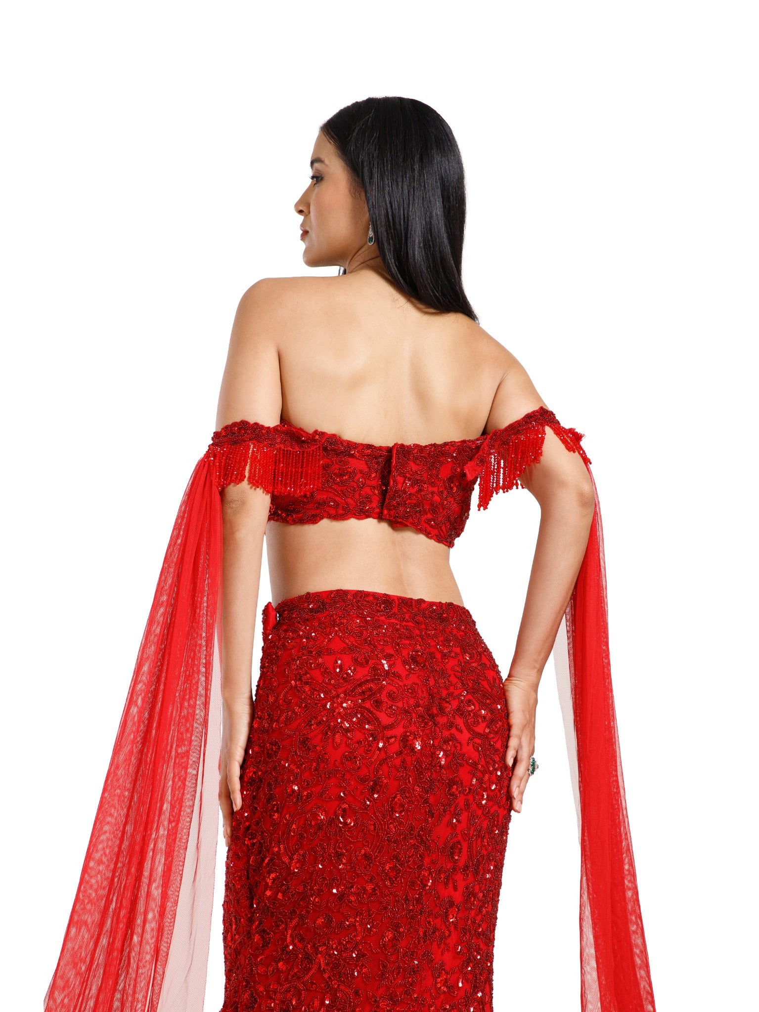 Detailed back view of the Crimson Reign Lehenga blouse by DEEPANSHI MASSEY LABEL showcasing intricate crimson embroidery, embellished off-shoulder detailing and the fitted waistband of the mermaid skirt.