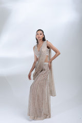 Opaline Sharara by DEEPANSHI MASSEY LABEL showcasing a pearl-embellished champagne tissue outfit with a sleeveless blouse, draped dupatta and elegant wide-leg sharara pants.