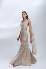 Full-length view of the Opaline Sharara by DEEPANSHI MASSEY LABEL featuring delicate pearl embellishments, a sleeveless designer blouse and a graceful champagne tissue sharara.