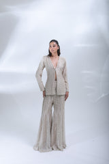 Front view of the champagne pearl co-ord set featuring a deep V-neck jacket and embellished flared trousers.